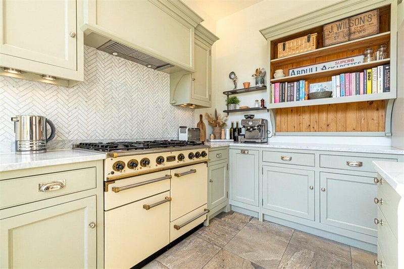 The kitchen also contains a Belfast sink, larder unit, integrated dishwasher and washing machine and Falcon range cooker with gas burners and electric oven. 