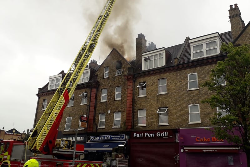 Ten fire engines and around 70 firefighters tackled a fire in Cricklewood Broadway on April 21.  A third floor flat and loft of a building containing a shop and flats was destroyed. Four people and a dog were led to safety from the building by firefighters. A man was treated at the scene by London Ambulance Service crews. The fire is thought to have been accidental and caused by a fault with an extractor fan. (Photo by LFB) 