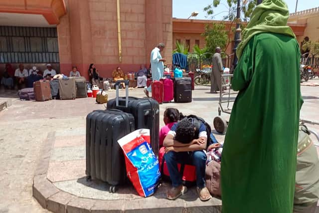 People who fled war-torn Sudan wait at a railway station in the Egyptian city of Aswan (Photo by -/AFP via Getty Images)