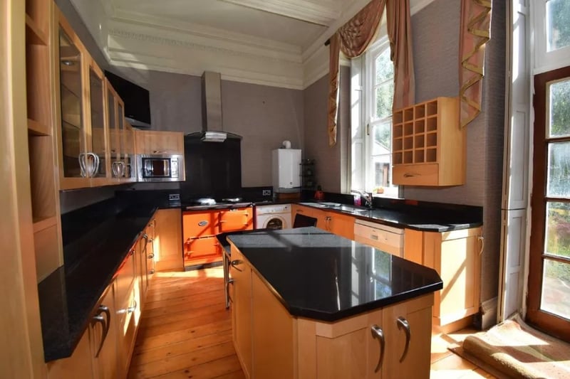The kitchen has granite worktops, a central island and Aga for cooking