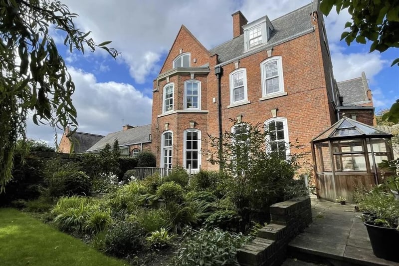 The property features a communal garden and comes with two garages 