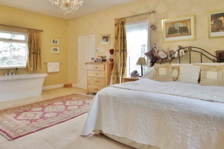 The property has five bedrooms, including the master, which features a tub.