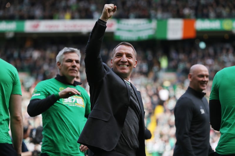 Jubilant Celtic manager Brendan Rodgers waves to someone in the stands during a lap of honour.