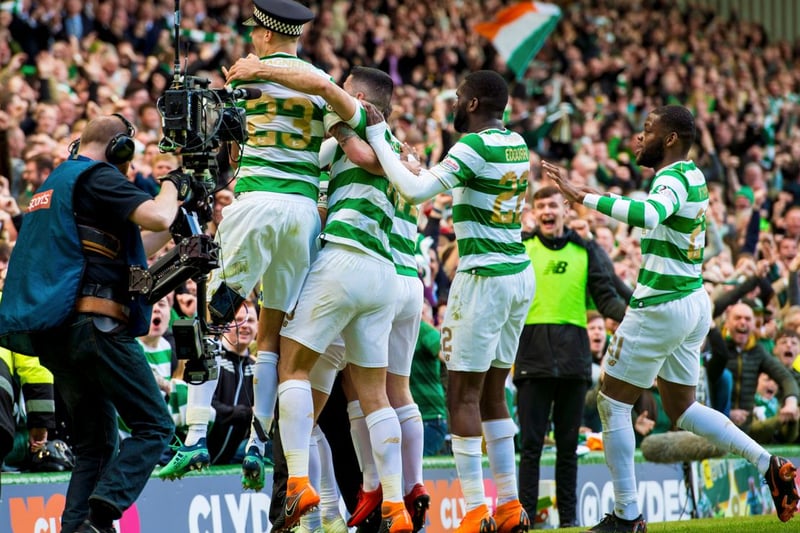Mikael Lustig (far left) is pictured wearing a Police helmet as he celebrates in front of the packed stands.