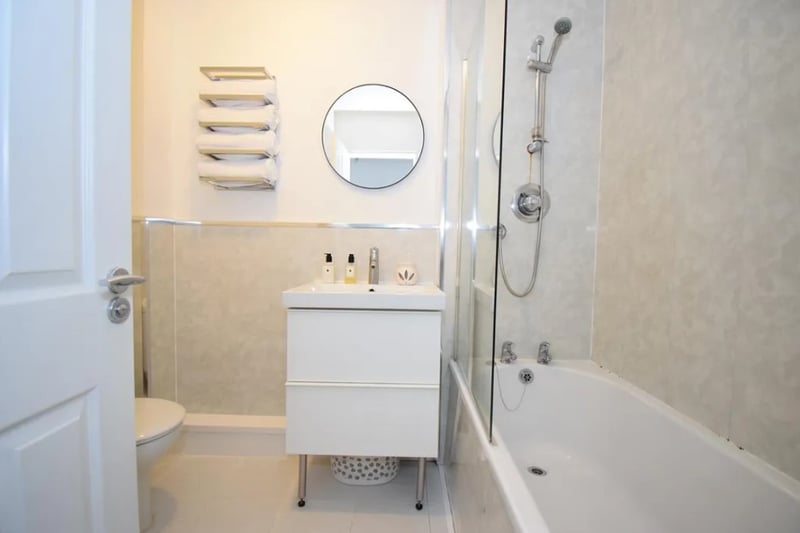 The main bathroom on the property is slightly small but features a bath and shower combo