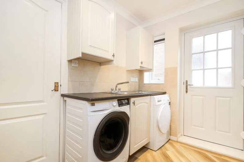 A small area dedicated to a washer and drier, allowing for more space elsewhere