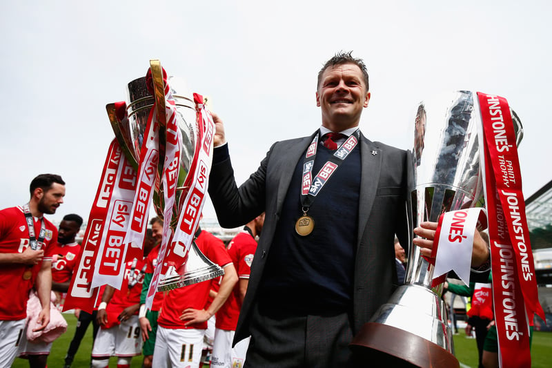 Steve Cotterill celebrates with the the League One title and the EFL Trophy. 