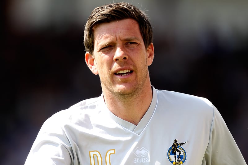 Darrell Clarke takes to the dugout as he soaks up the atmosphere. 