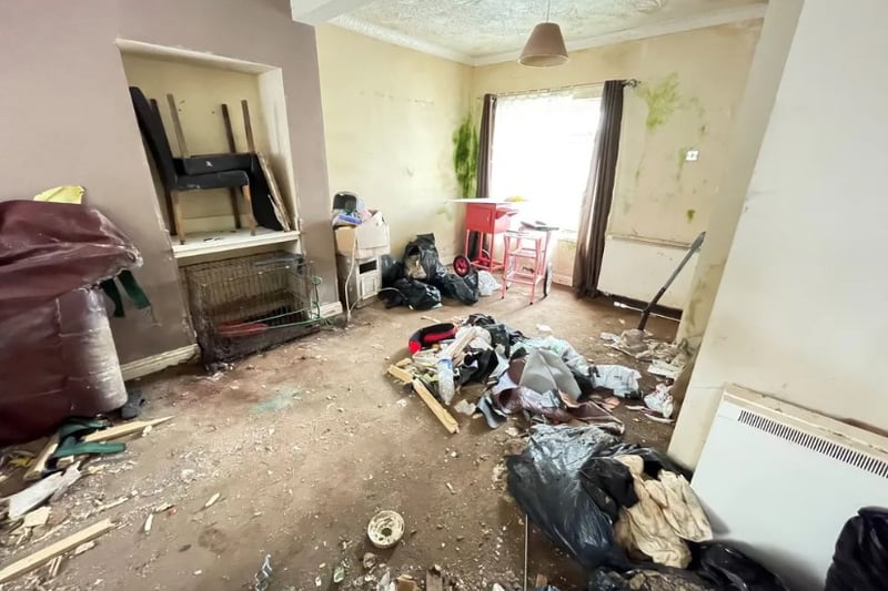 The living room of the property is spacious but requires a good clean to get rid of the mould on the walls