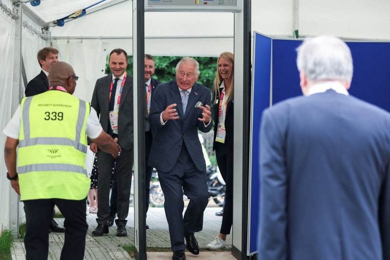 Britain’s Prince Charles, Prince of Wales reacts as he walks through a metal detector as he arrives for a visit to the Athletes Village at The University of Birmingham in Birmingham, central England, on July 28, 2022, on the eve of the Commonwealth Games. (Photo by PHIL NOBLE / POOL / AFP) (Photo by PHIL NOBLE/POOL/AFP via Getty Images)