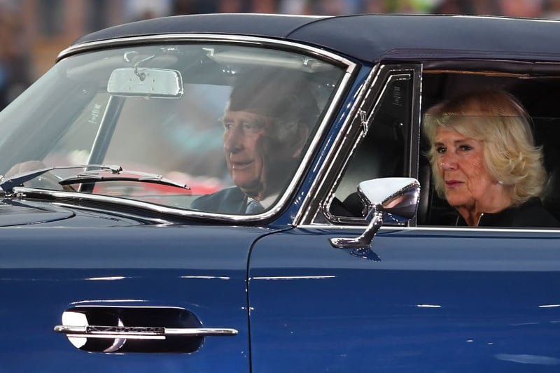 King Charles(L) drives with Queen Consort Camilla in an Aston Martin sports car into the opening ceremony for the Commonwealth Games, at the Alexander Stadium in Birmingham, central England, on July 28, 2022. (Photo by ANDY BUCHANAN/AFP via Getty Images)