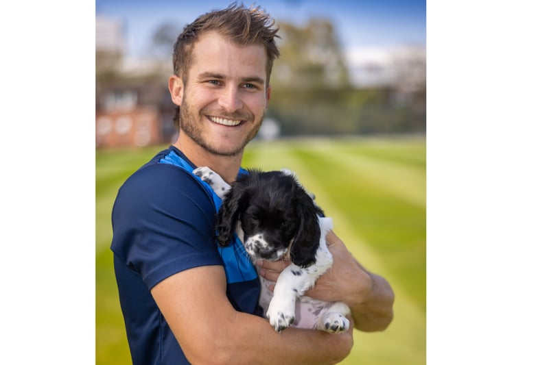 Hainy, the pup, was named after Warwickshire batsman Sam Hain - who is holding him here. (Photo - Warwickshire CCC)