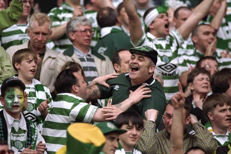 Celtic fans celebrate after a Scottish Premier League match against St Johnstone at Celtic Park in 1998. Celtic won the match 2-0 to become the league champions for the first time since 1988. 