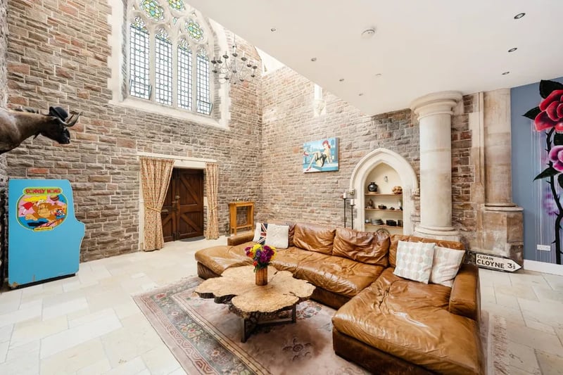 The entrance opens into an impressive living space with a dramatic ceiling height, creating a sense of space and light which then reduces, creating a snug living space. The original church features dress the room including a large stained glass tracery window, stone pilasters and carved archway.