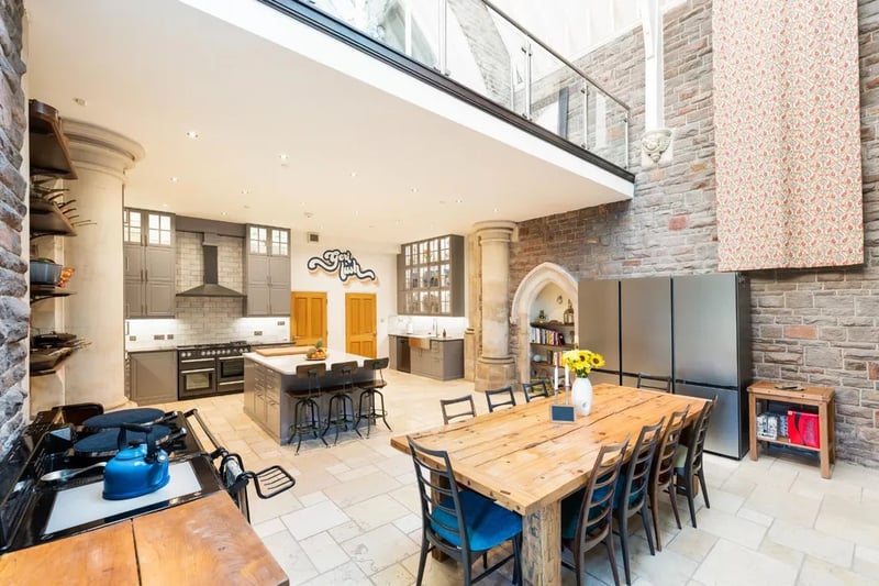 A doorway at the rear of the building leads into a beautiful kitchen and dining space which has been upgraded by the current owners. Sky lights and a large stained glass tracery window drop in plenty of natural light with a limestone tiled floor running throughout.