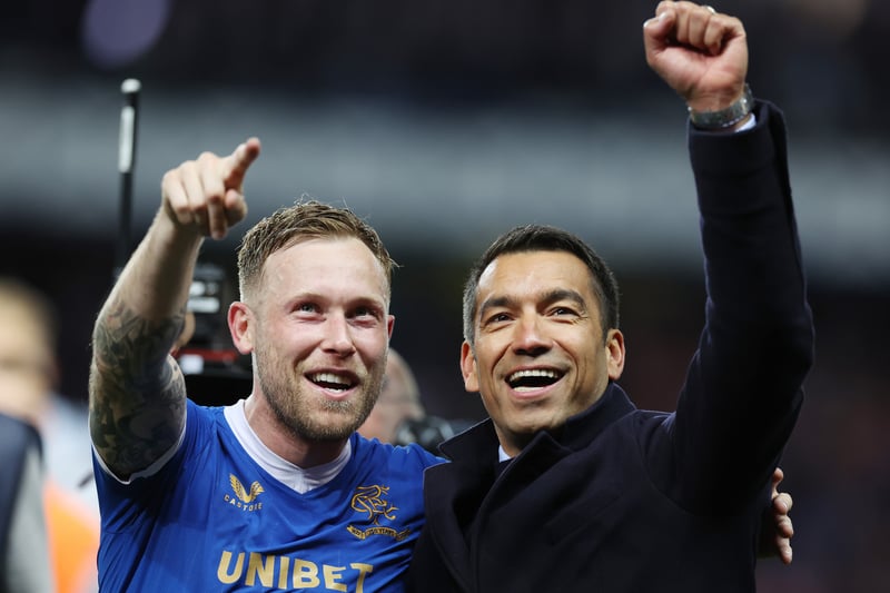 Scott Arfield and Van Bronckhorst wave to fans in the stand after the Dutchman successfully guided his side to Seville. 