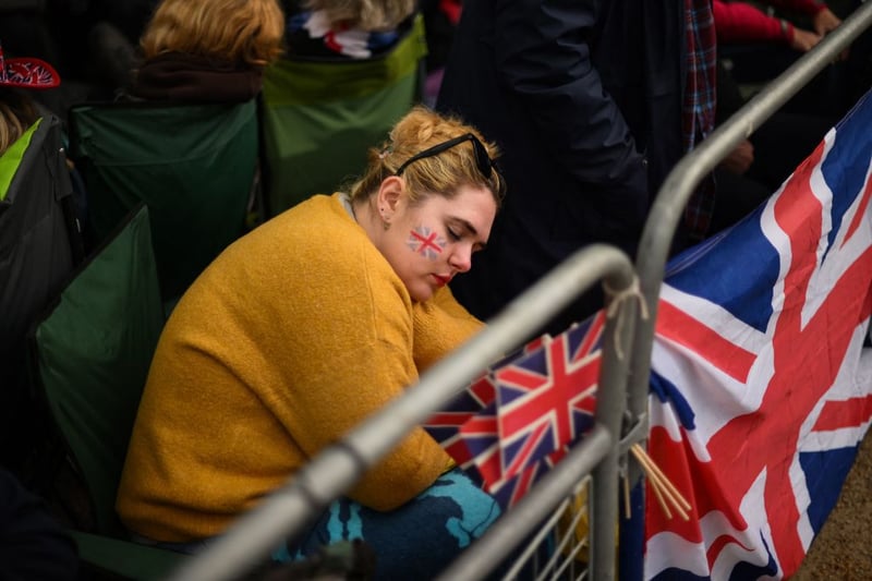 A royals fan resting ahead of the main event. (Photo by DANIEL LEAL/AFP via Getty Images)