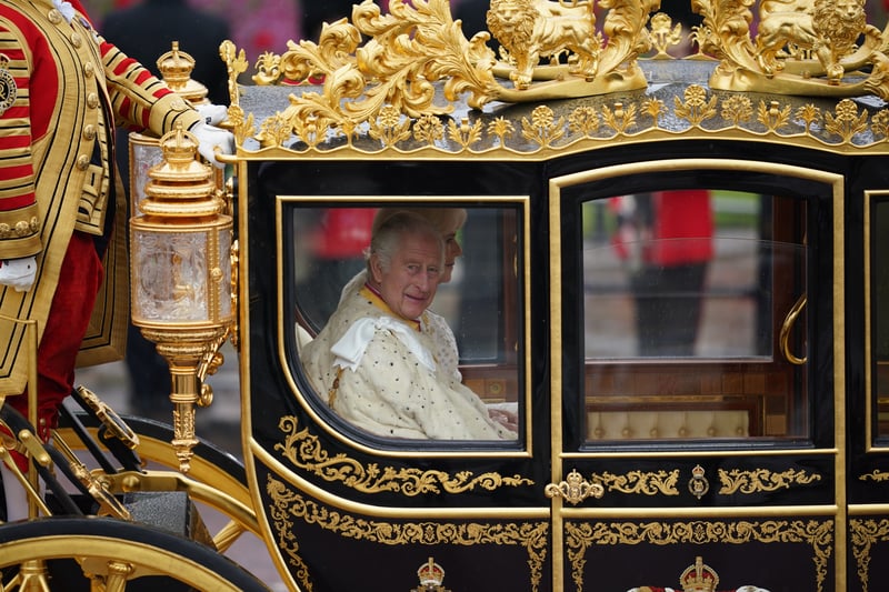 The King and Queen travelled to the ceremony at Westminster Abbey in the decadent royal carriage as rain poured down in London. (Credit: PA)