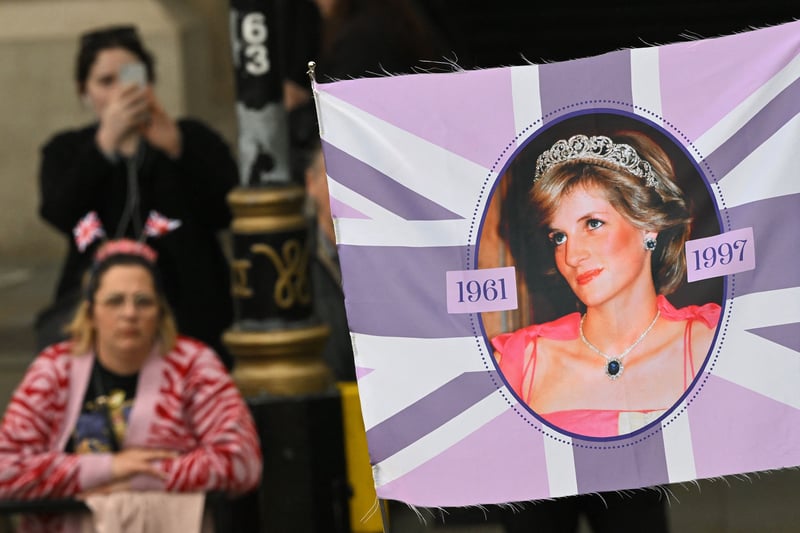 A pointed banner of the late Diana, Princess of Wales, in the crowd. (Photo by SEBASTIEN BOZON/POOL/AFP via Getty Images)
