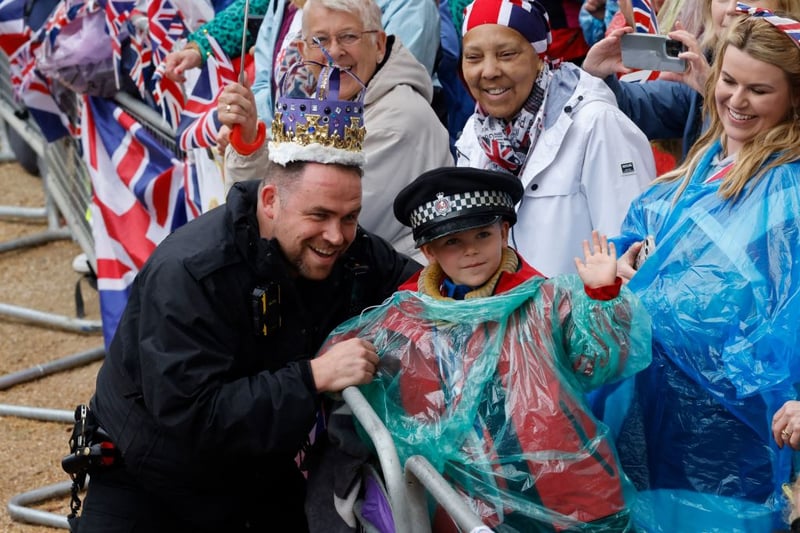 A police officer steals the king’s crown and enlists him to help meet community policing targets. (Photo by CARLOS JASSO/AFP via Getty Images)