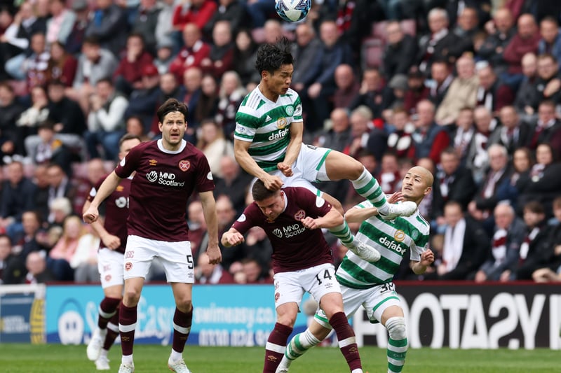 Celtic midfielder Reo Hatate jumps for the ball over Hearts’ Cammy Devlin as team-mate Daizen Maeda looks on.