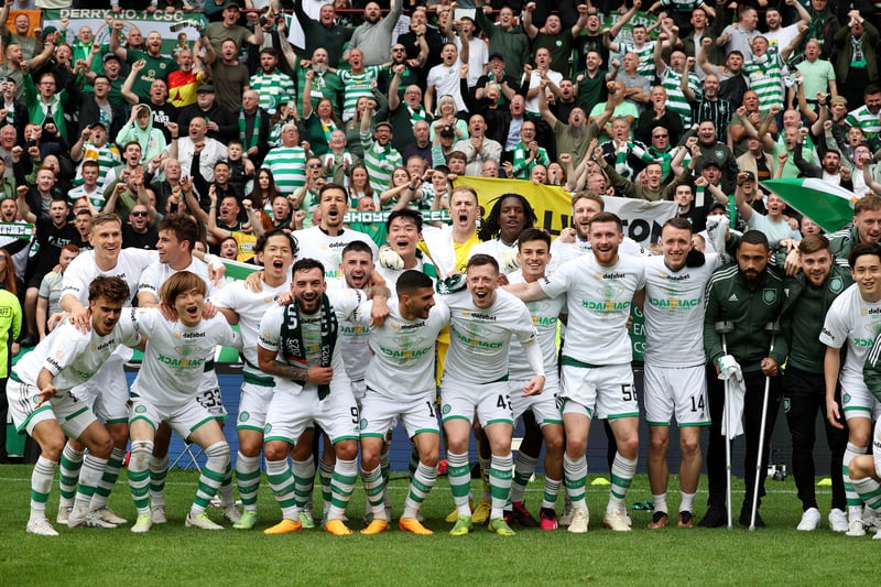 The Celtic players pose for a team photograph with supporters at Tynecastle. 