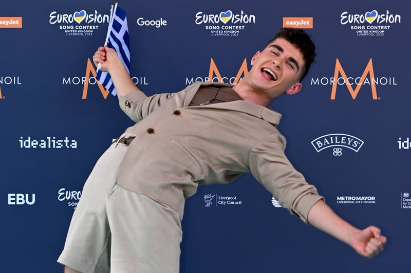 Victor Vernicos waves the Greek flag.