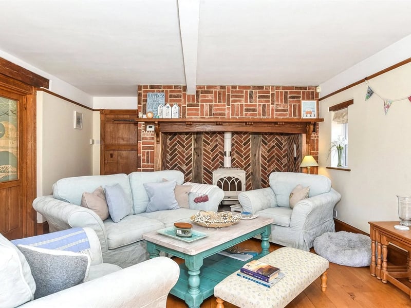The lounge features an Inglenook fireplace with an enamel slow combustion wood-burning stove