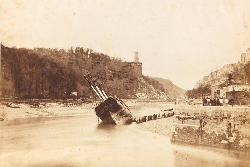 The wreck of the sailing ship Mary Ann Peters at the entrance to the docks at Rownham on March 31, 1857. Notice in the background the start of the Clifton Suspension Bridge which was completed seven years later.