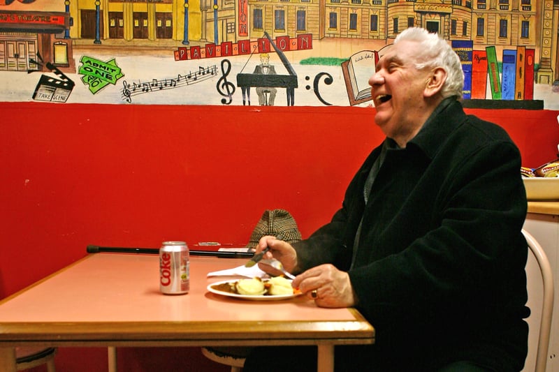 A regular customer enjoys his lunch at Paddy's Market