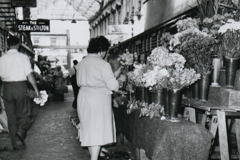 The flower market in the Glass Arcade pictured in 1958 - note the sign for the long-gone Steak & Stilton restaurant. Photo: Bristol Archives