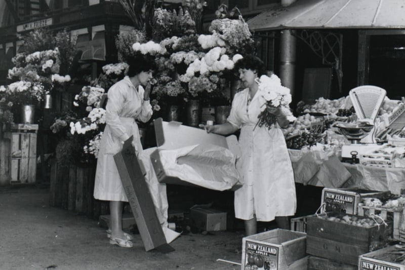 This stall in 1958 sold flowers, fruit and veg in the Glass Arcade - does anybody recognise the two ladies? Photo: Bristol Archives