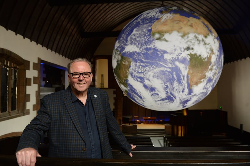 Director of the The Charles Rennie Mackintosh Society,  Stuart Robertson, stands under Gaia,