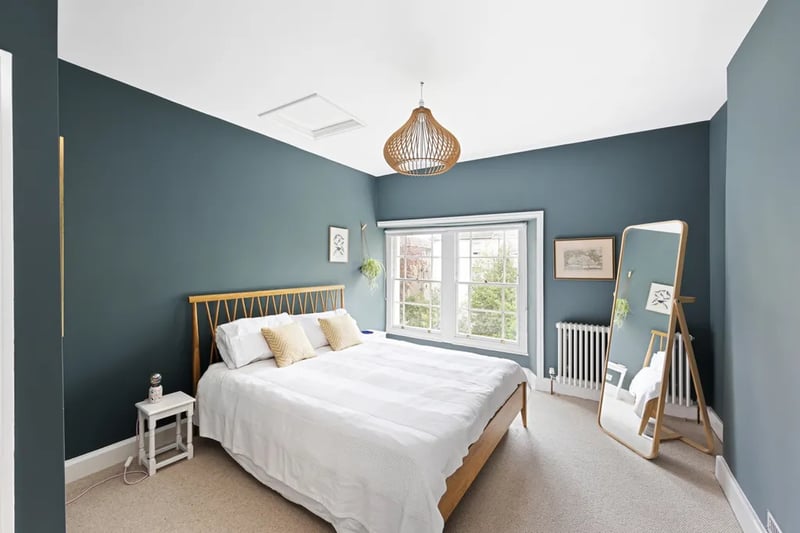 “Upstairs, across the top floor, lie two further double bedrooms. To the rear is a charming double bedroom with twin sash windows overlooking the garden, with a recessed cupboard providing access to the property’s boiler and heating system.”