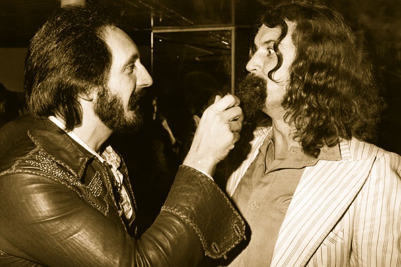 John Entwistle (The Who) gives a friendly tug on the beard of Scottish comedian Billy Connolly at the latter’s party at the London nightclub Legends. 