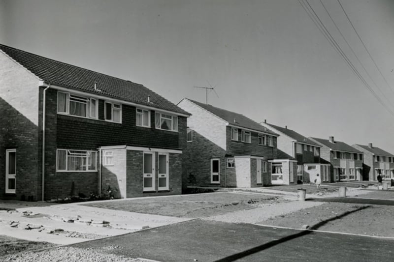 A row of newly built houses on Stockwood Road with bare front gardens.