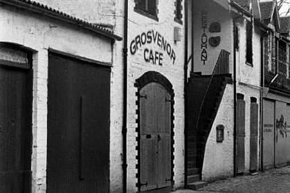 It survives in name, but Ashton Lane’s Grosvenor Cafe has changed beyond recognition. The Grosvenor, located a stone’s throw from the university, was a haunt for the city’s undergrads, musos, and celebs, attracting the likes of Orange Juice and Belle & Sebastian- who famously formed their band over a quiet cup of tea at the Grosvenor in 1996.   The Grosvenor’s cosy interior featured a number of wooden booths, which would, more often than not, lure you into engrossing conversation with complete strangers. After the original Grosvenor closed, Belle & Sebastian’s lead singer, Stuart Lee Murdoch reportedly saved one of the original booths and installed it in his kitchen.  The Grosvenor Cafe can now be found on the opposite side of the lane, incorporated within the Grosvenor Cinema, the city’s oldest-surviving picture house. Busy cocktail bar, Vodka Wodka now occupies the premises of the former cafe, but gone are the days of the Grovcoff (ice cream sprinkled with ground coffee) and pizzas topped with fried egg..(Pic:Dave McClure)