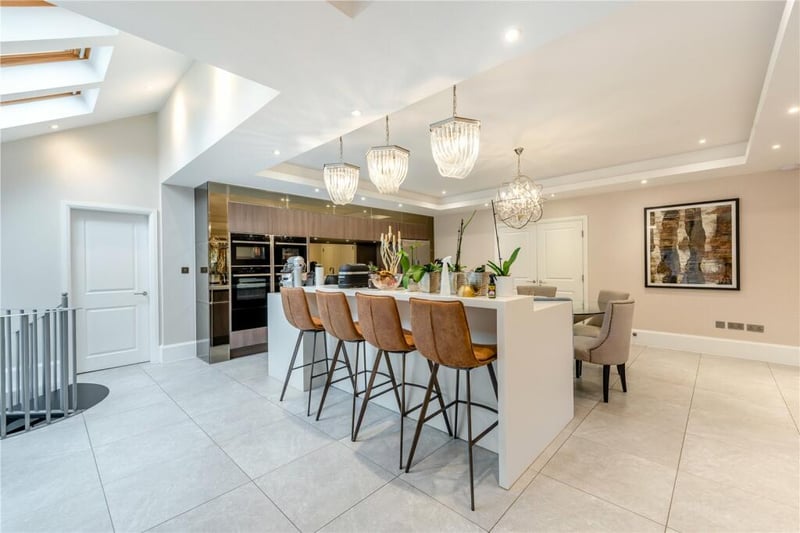 The bespoke stylish kitchen would be perfect for hosting a dinner party.
