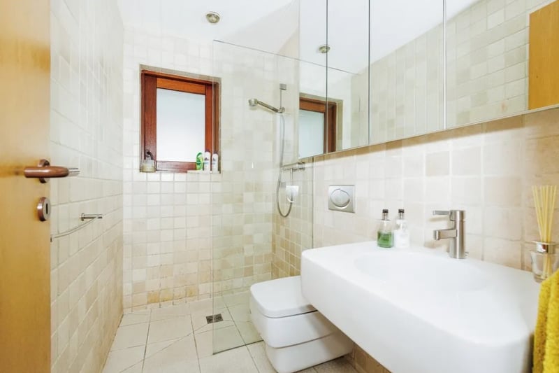 The property has three bathrooms with the first featuring a walk in shower