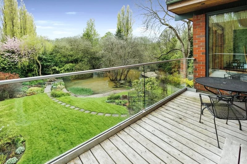 The first floor features a spacious balcony that overlooks the stunning garden