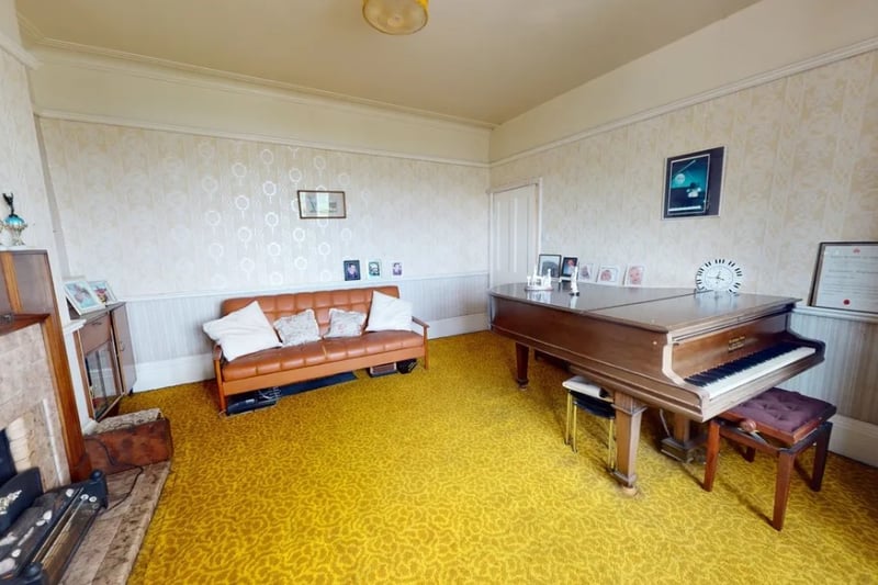 The reception room is a good size and currently is the home to a large piano