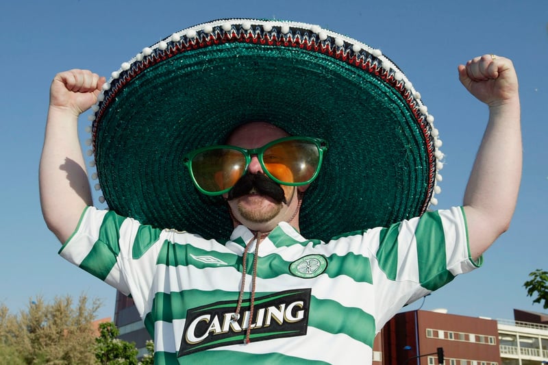 One fan shows off his wacky sunglasses, moustache and sombrero outside the ground.