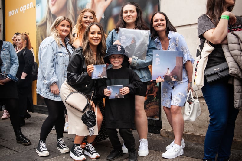 Lewis Capaldi fans pose with his latest album Broken by Desire to be Heavenly Sent. 