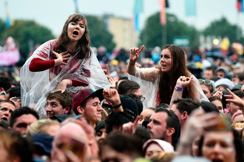 Fans listen to English rock band The 1975 as they perform on the Main Stage. 