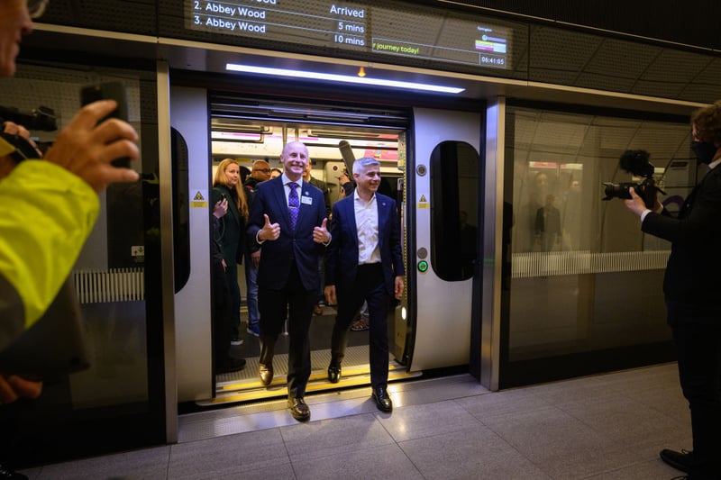 The mayor of London Sadiq Khan (R) and former TfL Commissioner Andy Byford disembark after travelling on the first eastbound train on the Elizabeth Line as it opens to the public at Paddington Station on May 24, 2022