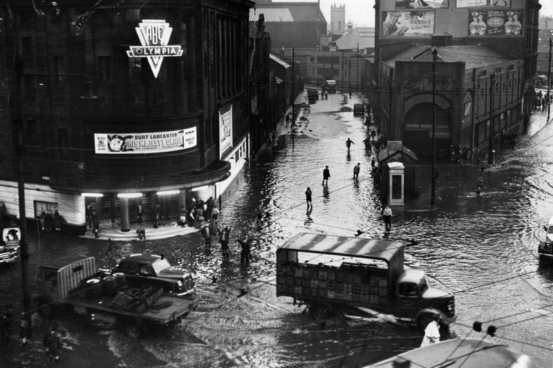 Bridgeton Cross, Glasgow, is inundated with floodwaters after torrential rains caused rivers to burst their banks. 