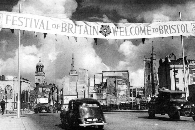 The Festival of Britain decorations in June 1951. Medieval St Nicholas Church stands gutted and still roofless after the Blitz. On the right, only the tower remains of St Mary le Port church.