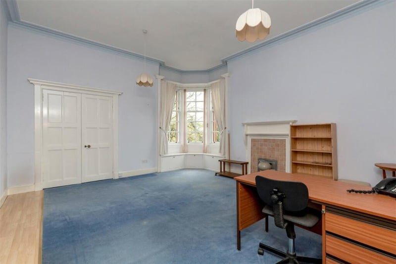 An office in the property with some blue carpets!