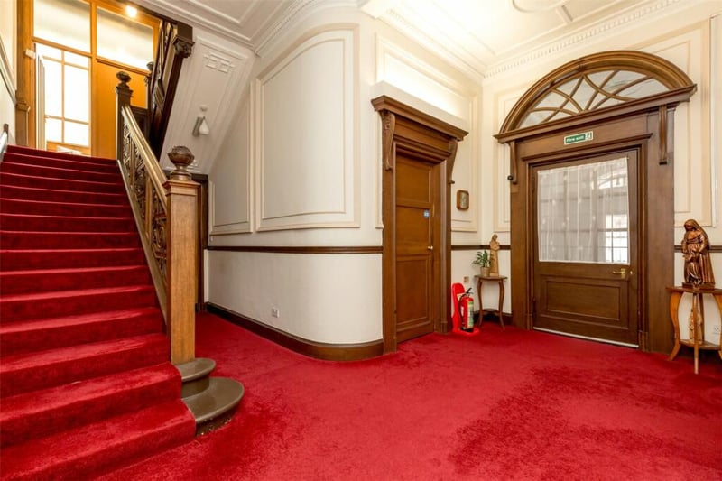 The staircase in the reception hall that leads into the four floors of the property