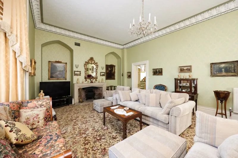“The dual aspect sitting room has large bay windows to its southerly and Westerly aspects. Impressive open hearth fireplace and some lovely period detail and furnishings. To give it scale the room itself is larger than many one bedroom apartments.”